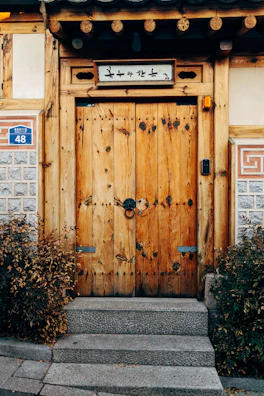 Welcoming entrance of Nivasara guest house with rustic wooden doors.