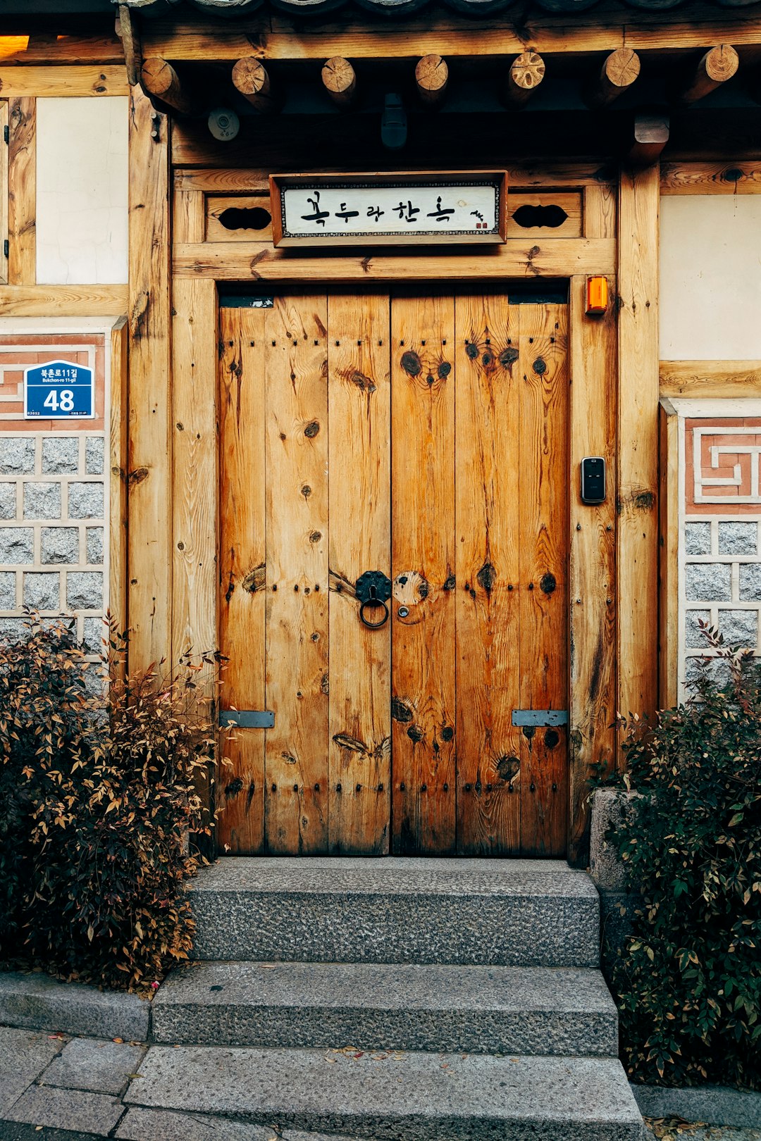 brown wooden door with black metal padlock