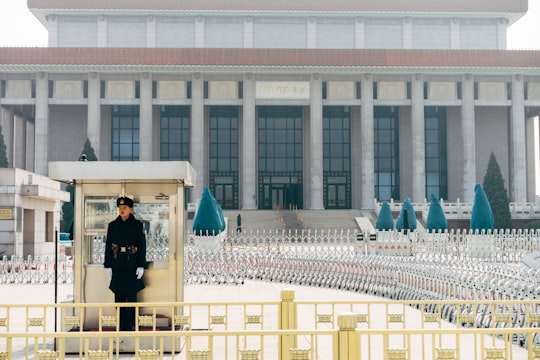 man in black jacket standing on white concrete building during daytime in Tiananmen Square China