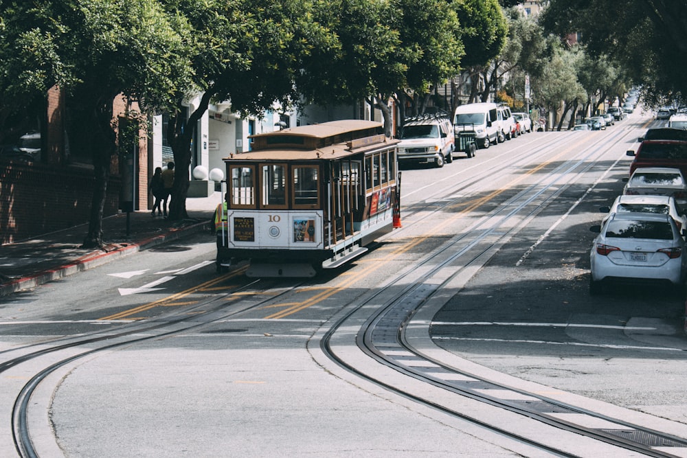 yellow and white tram on road during daytime