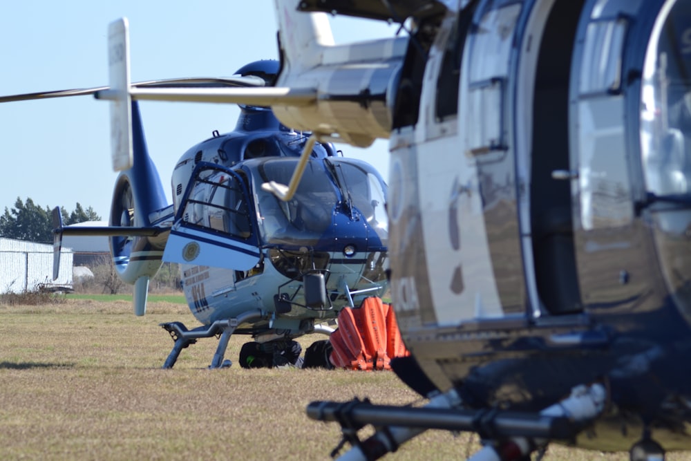 gray and black helicopter on green grass field during daytime