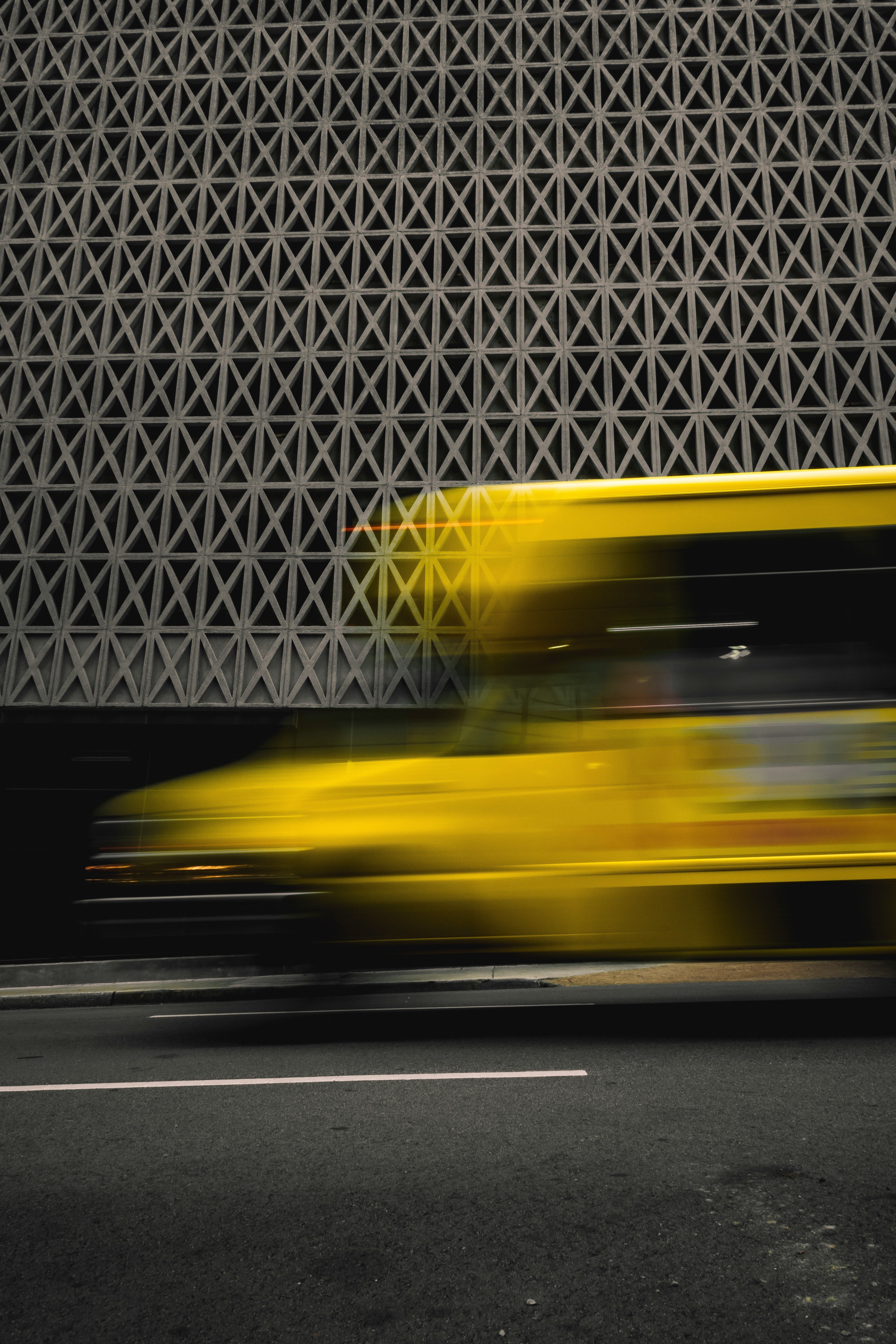 yellow car on gray asphalt road