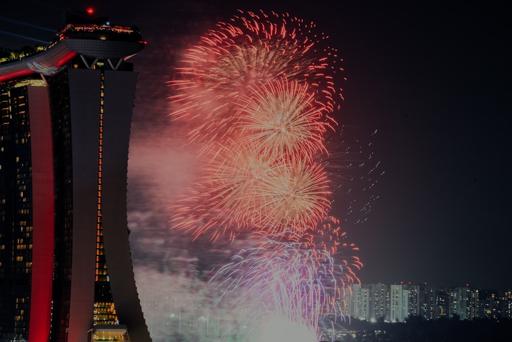 fireworks display over city buildings during night time