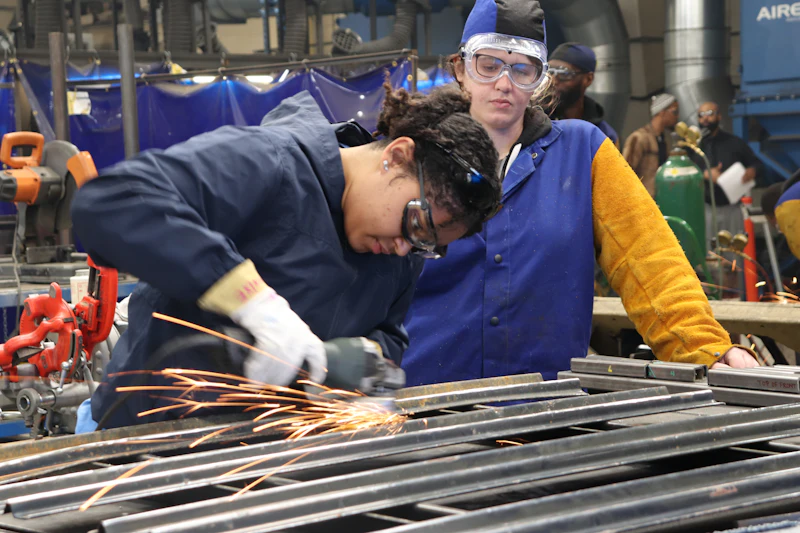 A trainee in a work vest at a vocational training site