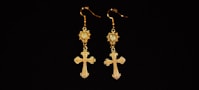 gold cross pendant necklace with black background