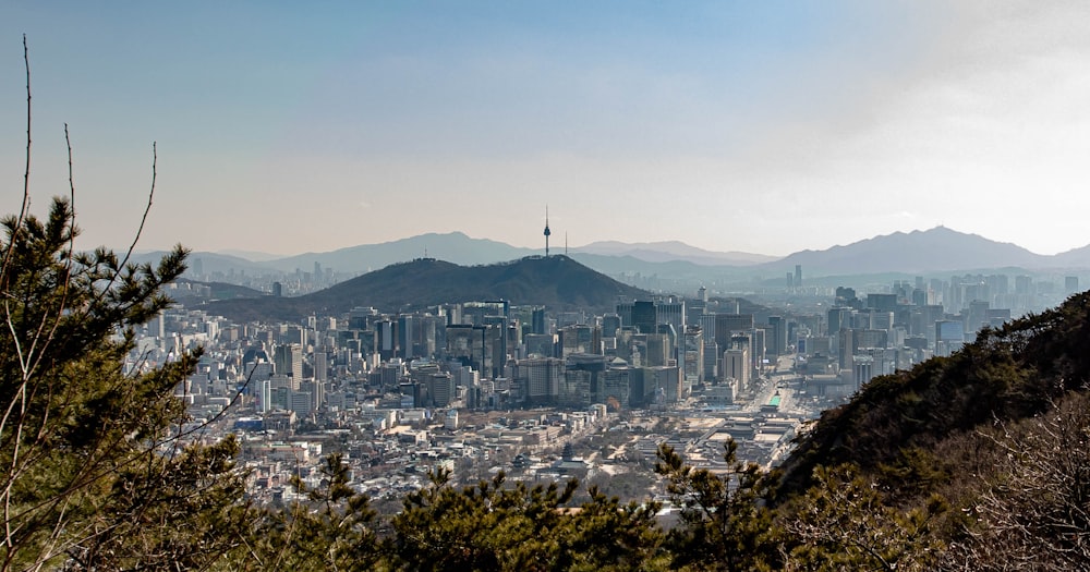 city buildings near mountain under blue sky during daytime