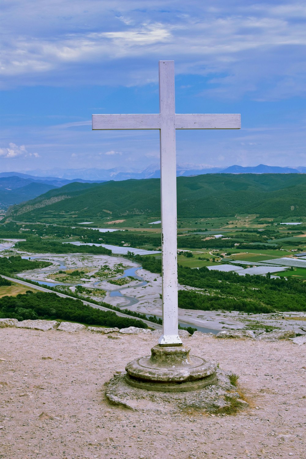 white cross on green grass field during daytime