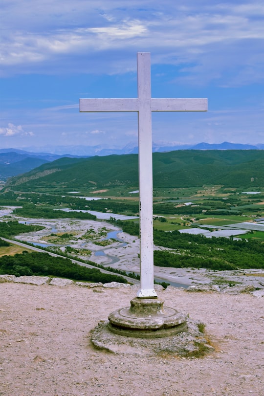 white cross on green grass field during daytime in Ganagobie France