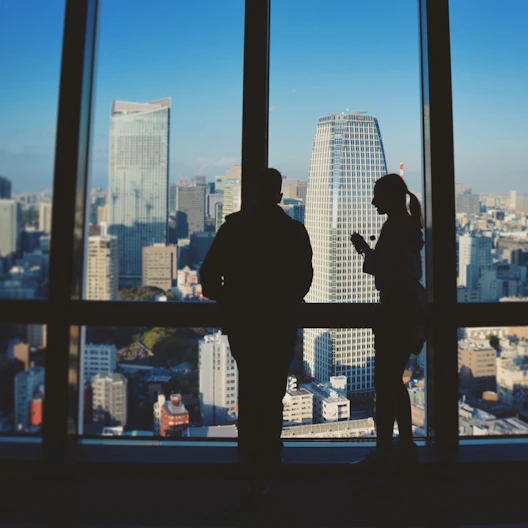 silhouette of man standing in front of glass window