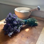 purple flowers on brown wooden table