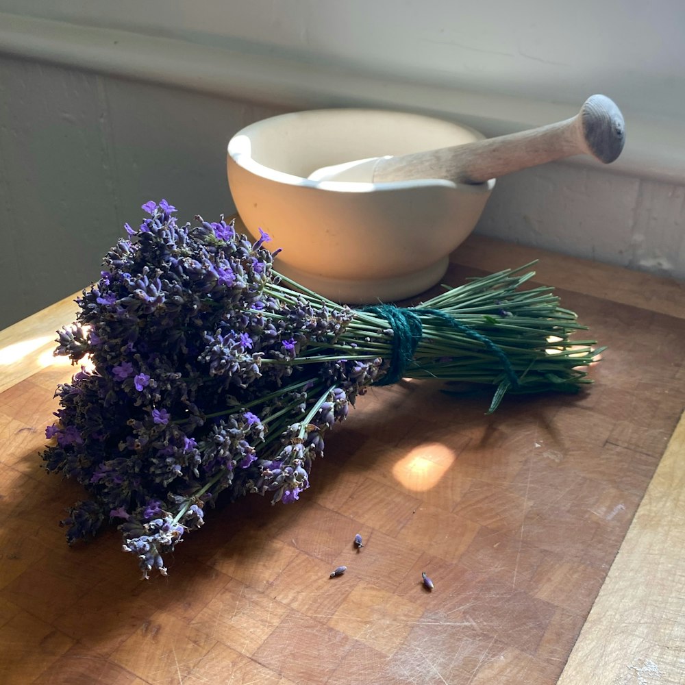 purple flowers on brown wooden table