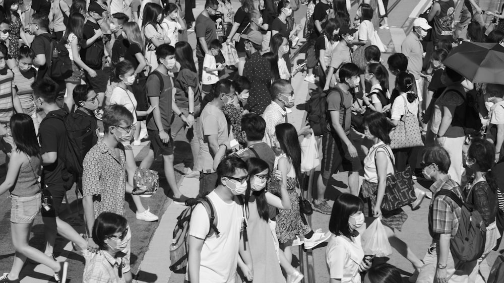 grayscale photo of people gathering on street