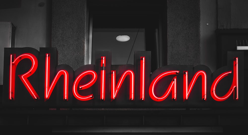 a red neon sign that reads rheineinland