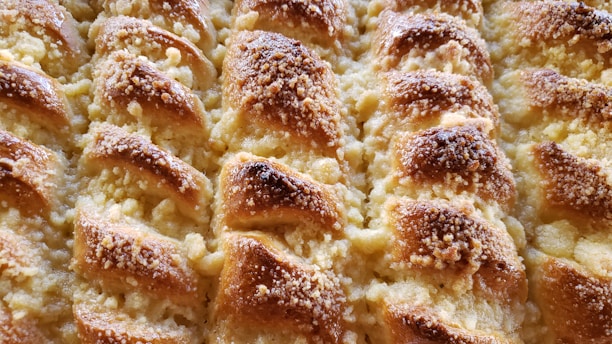 A close-up of a freshly baked pastry with a golden crust.