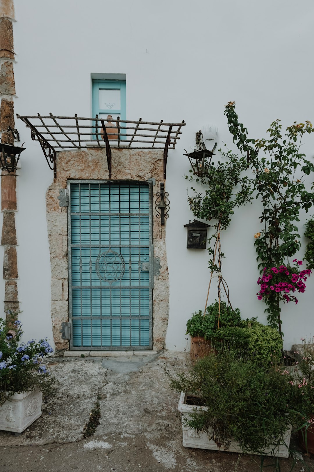 blue wooden window on white concrete building