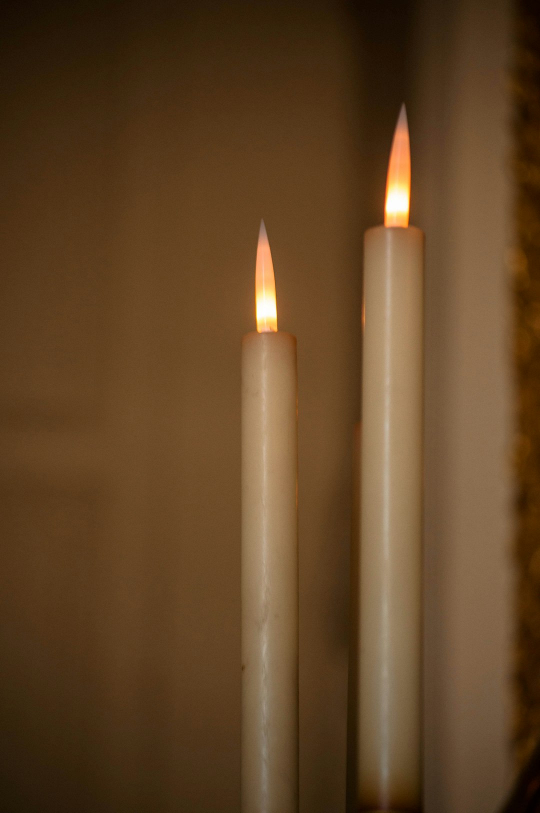 white candles on black surface