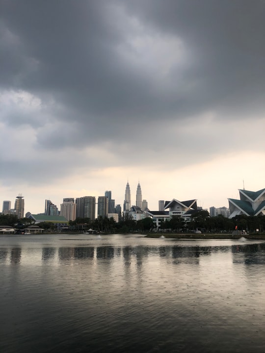 city skyline under cloudy sky during daytime in Taman Tasik Titiwangsa Malaysia
