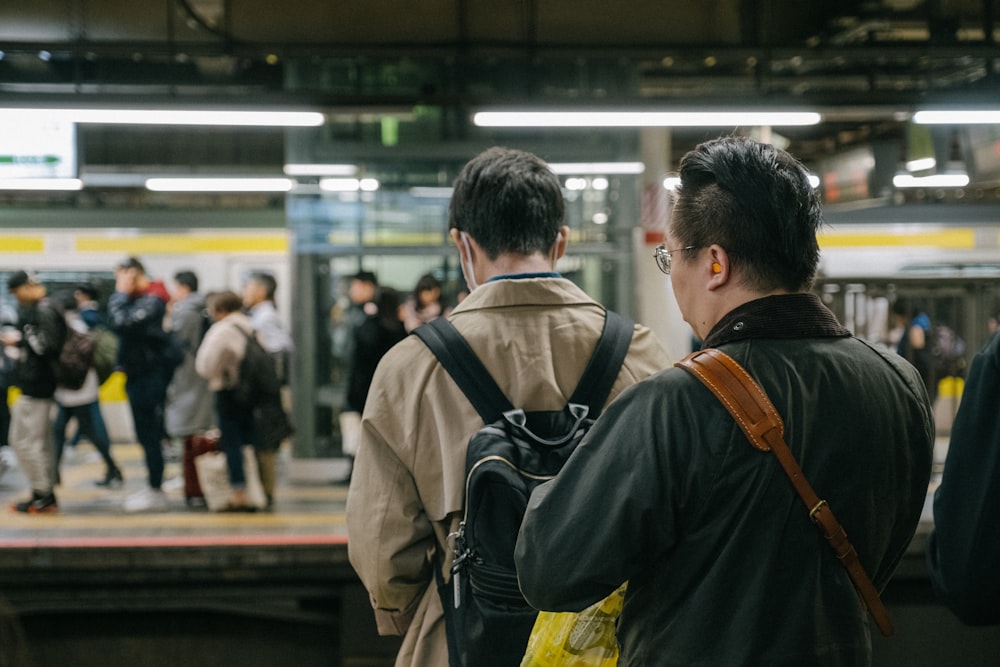 man in black shirt carrying black backpack