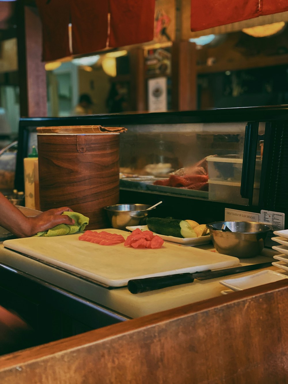 a person cutting up vegetables on a cutting board