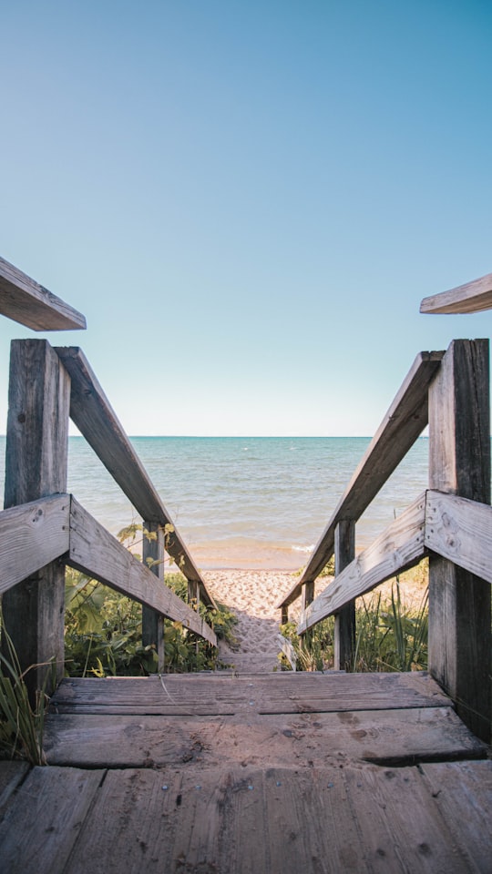 brown wooden bridge over the sea during daytime in Traverse United States