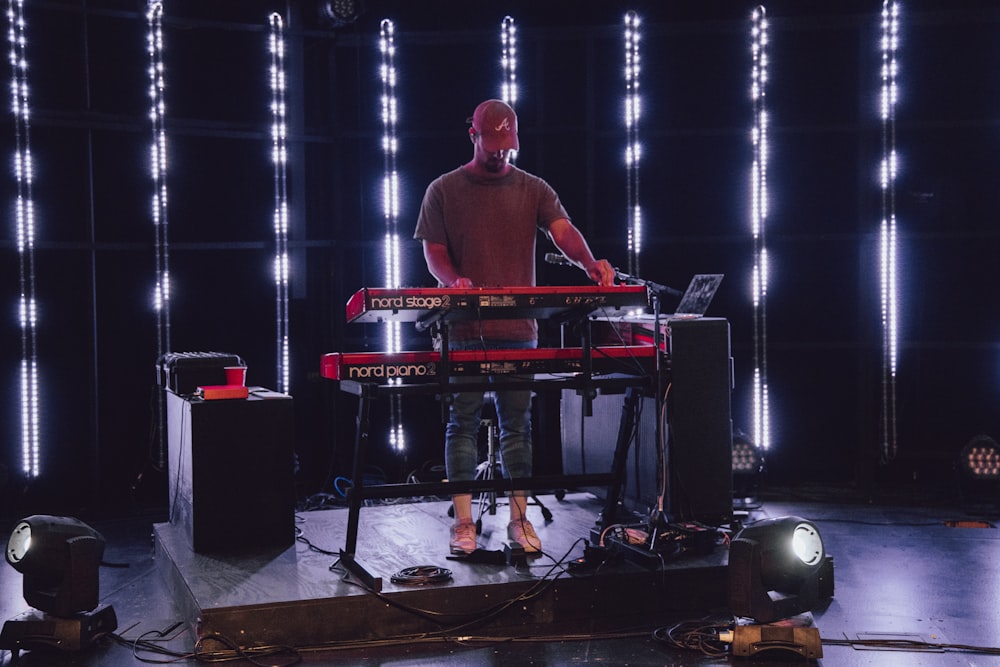 man in red shirt playing piano