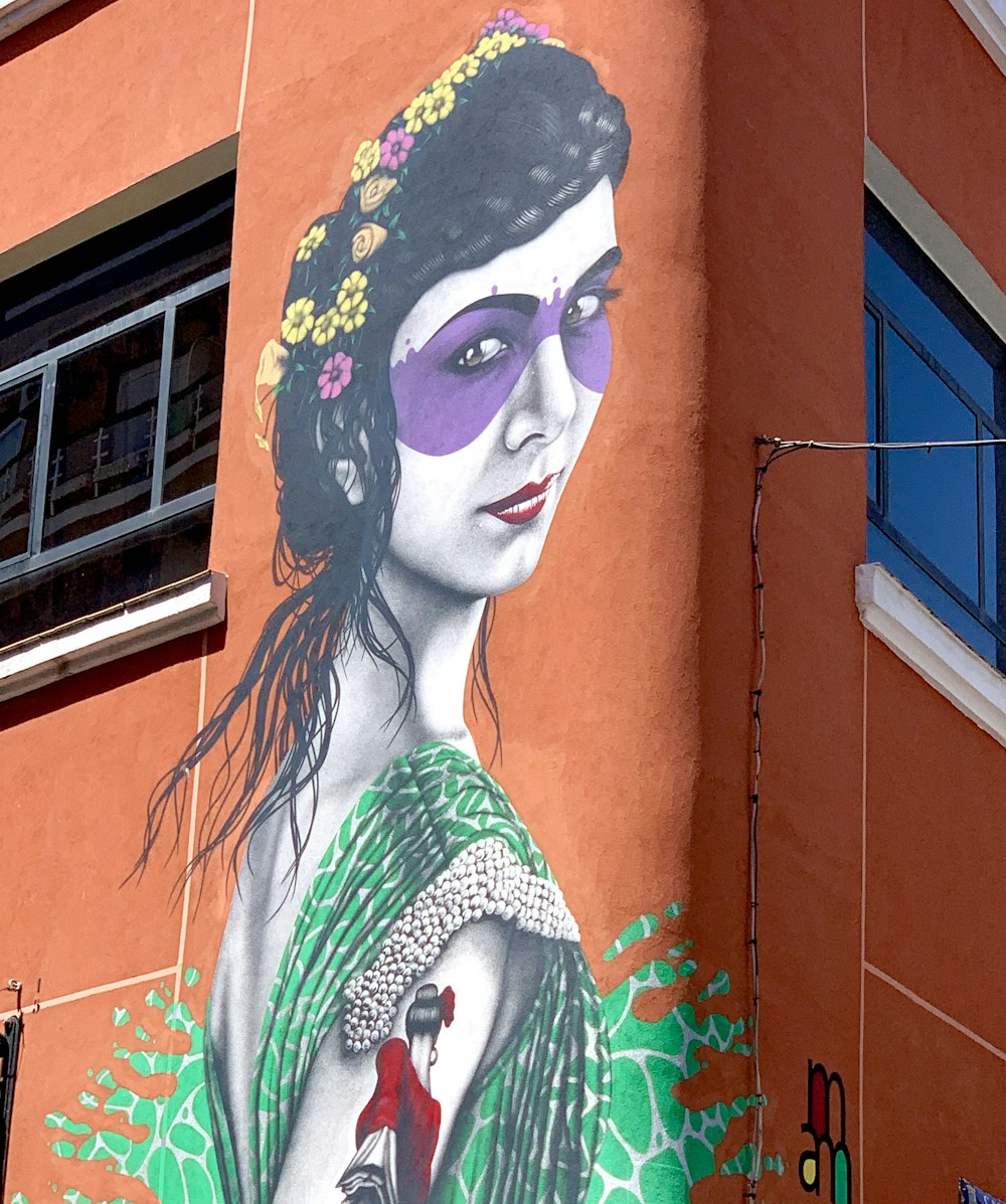 woman in green and white floral dress painting