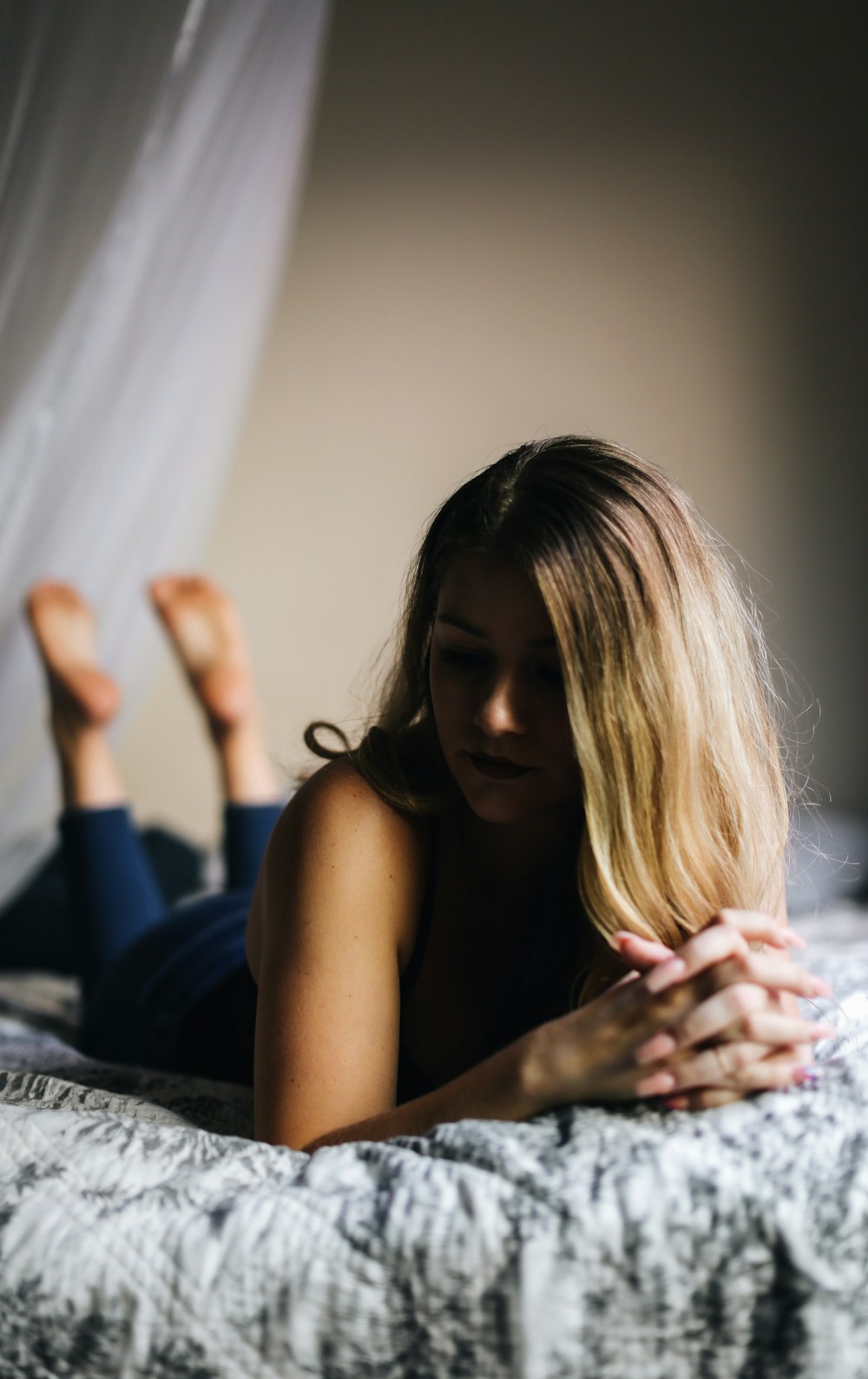 woman in black tank top sitting on bed