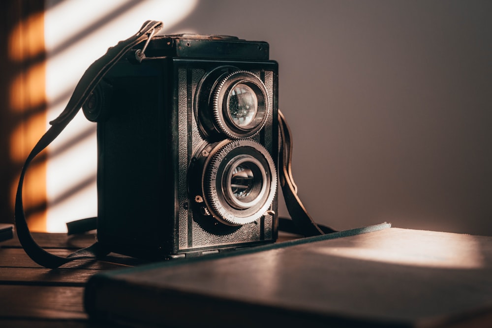 black camera on brown wooden table