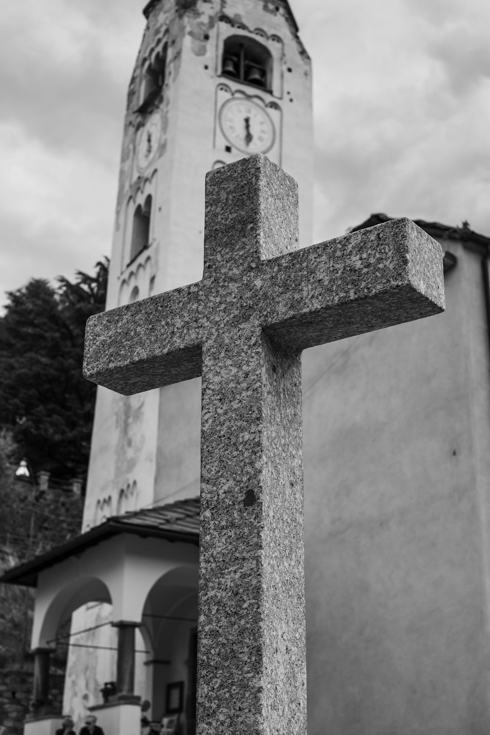 grayscale photo of cross on top of building