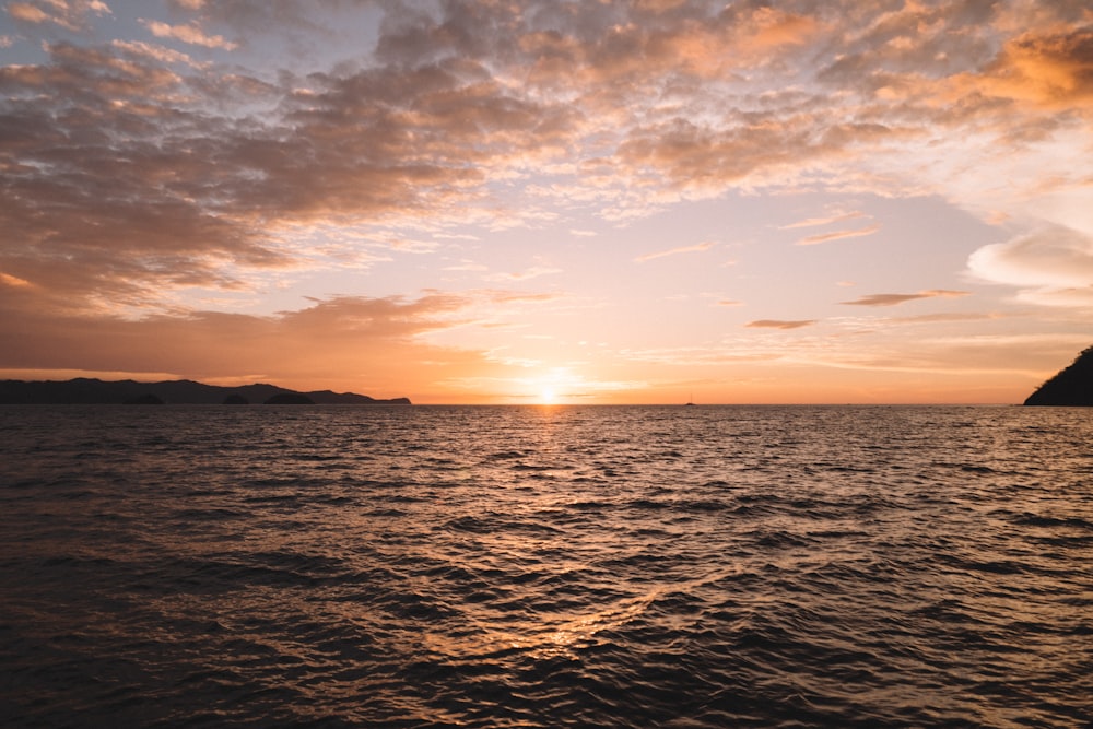 body of water during sunset