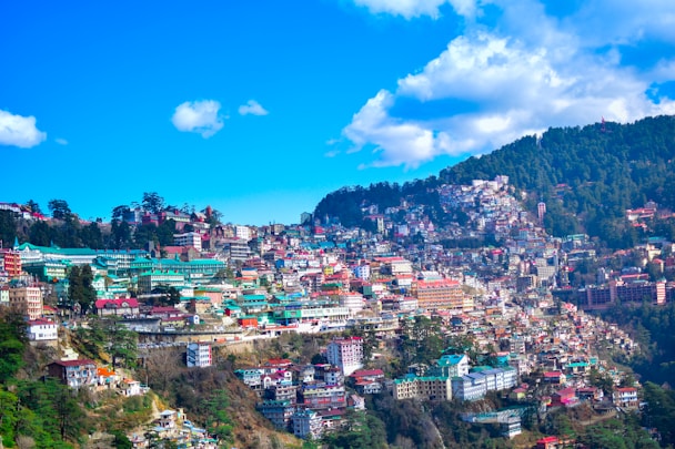 city near mountain under blue sky during daytime