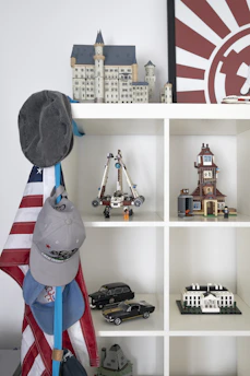 An elegant display of a completed architectural block model on a living room shelf.