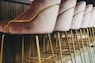 brown wooden framed white padded chair