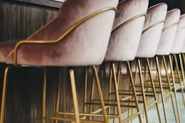brown wooden framed white padded chair