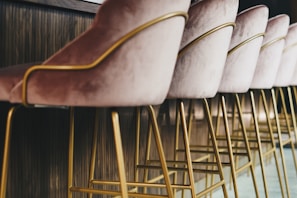 brown wooden framed white padded chair