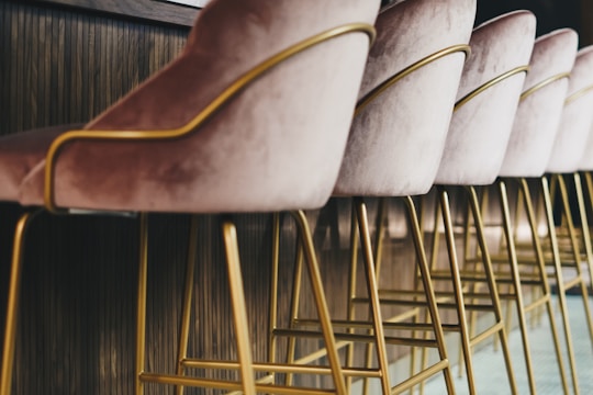 brown wooden framed white padded chair