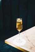 clear wine glass with yellow liquid
