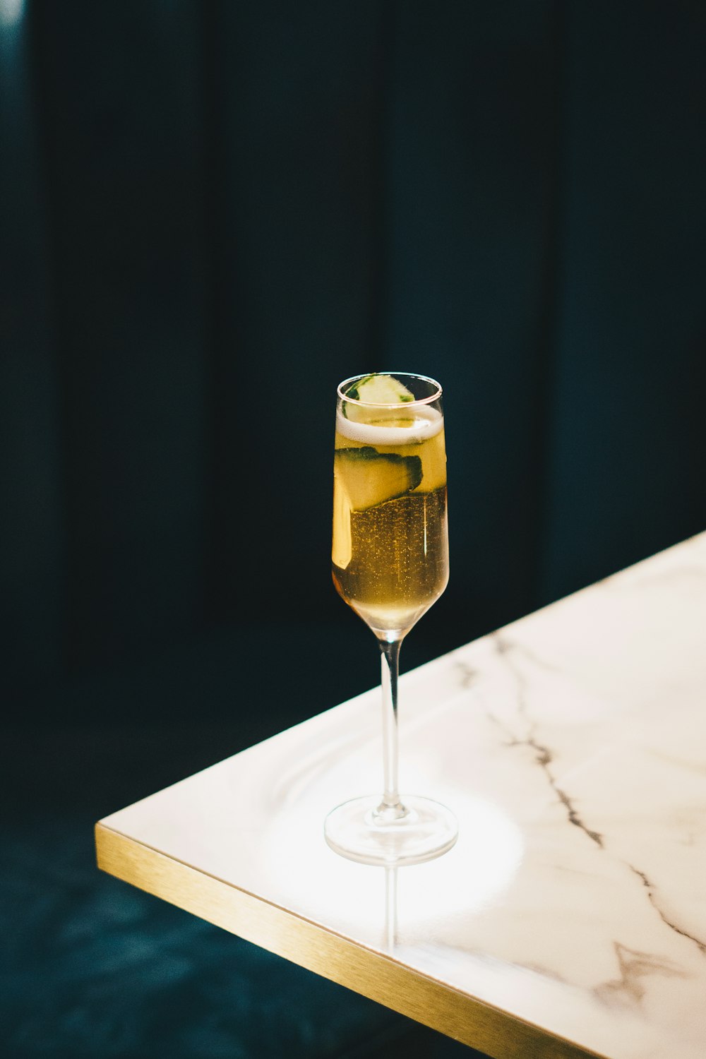 clear wine glass with yellow liquid