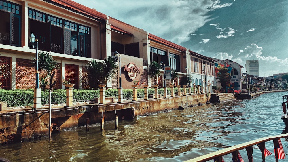 brown and white concrete building near body of water during daytime