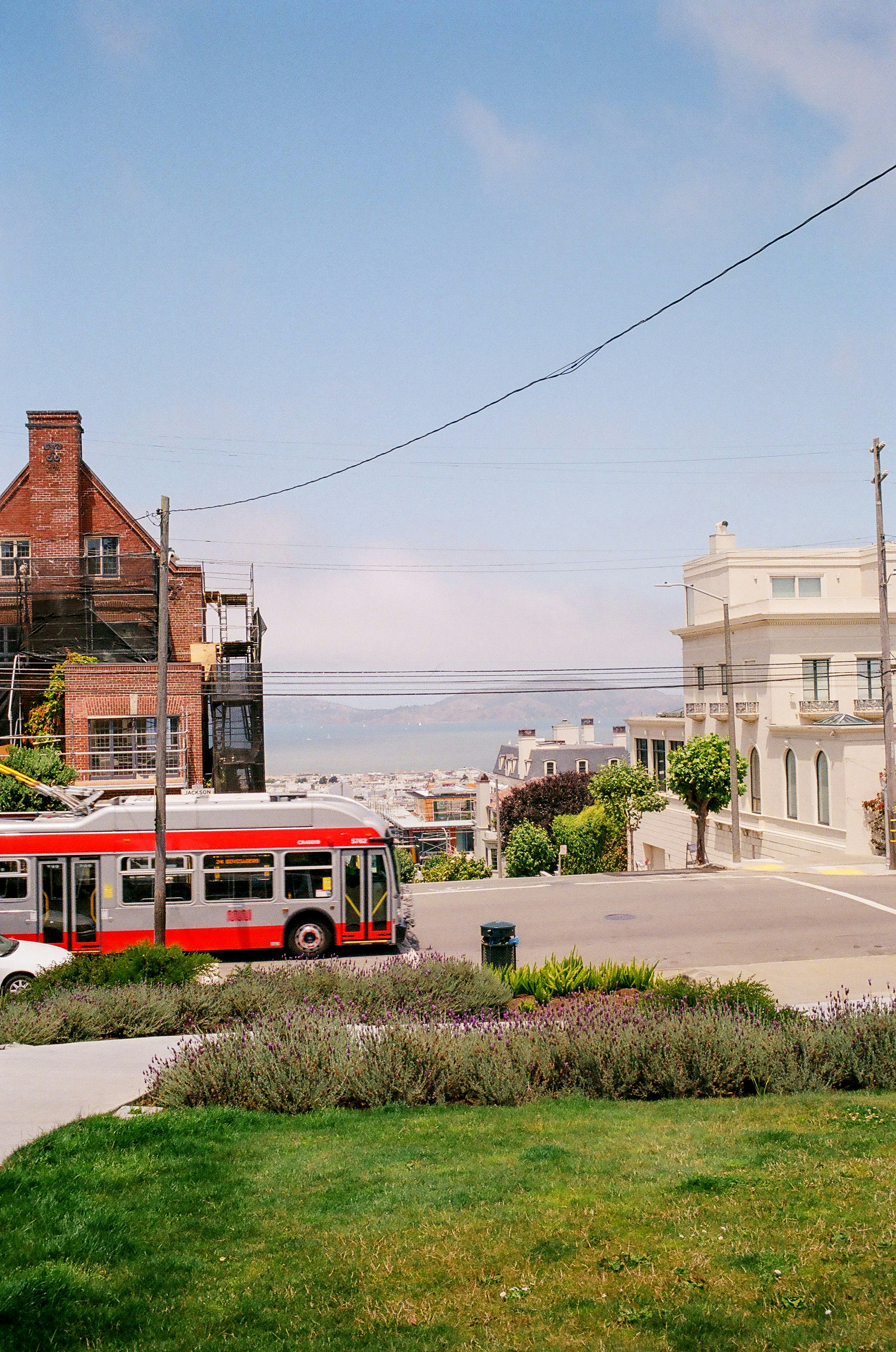 Bus rouge sur la route près du bâtiment pendant la journée