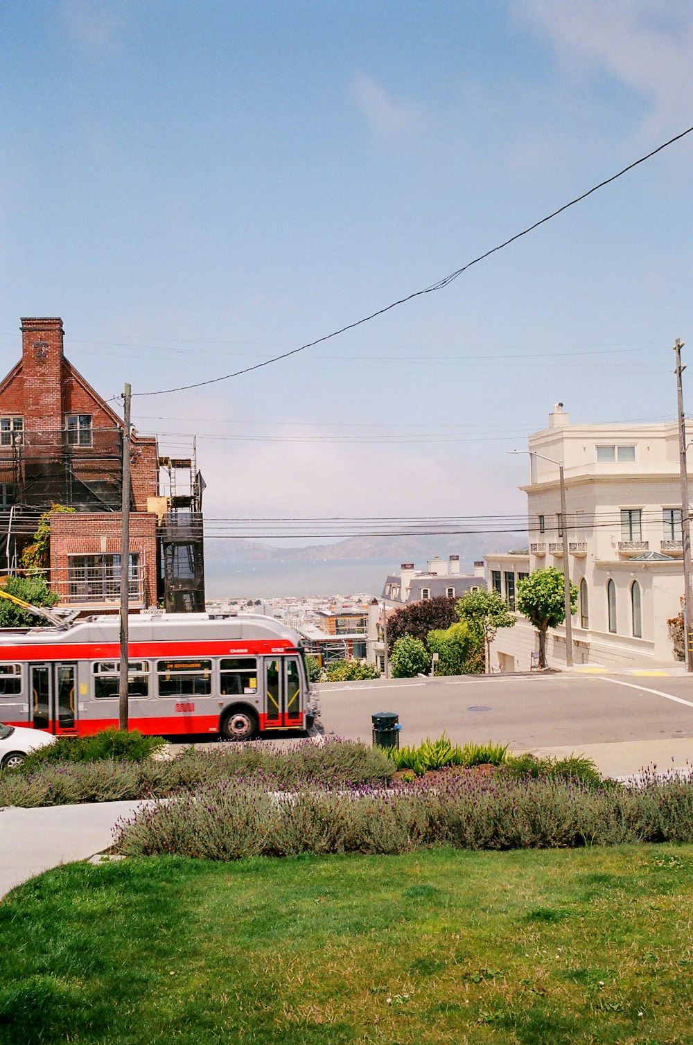 red bus on road near building during daytime