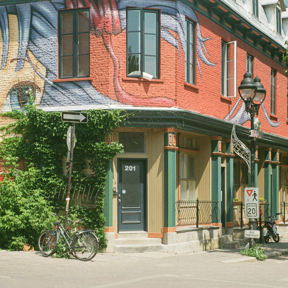 black bicycle parked beside brown and white concrete building during daytime