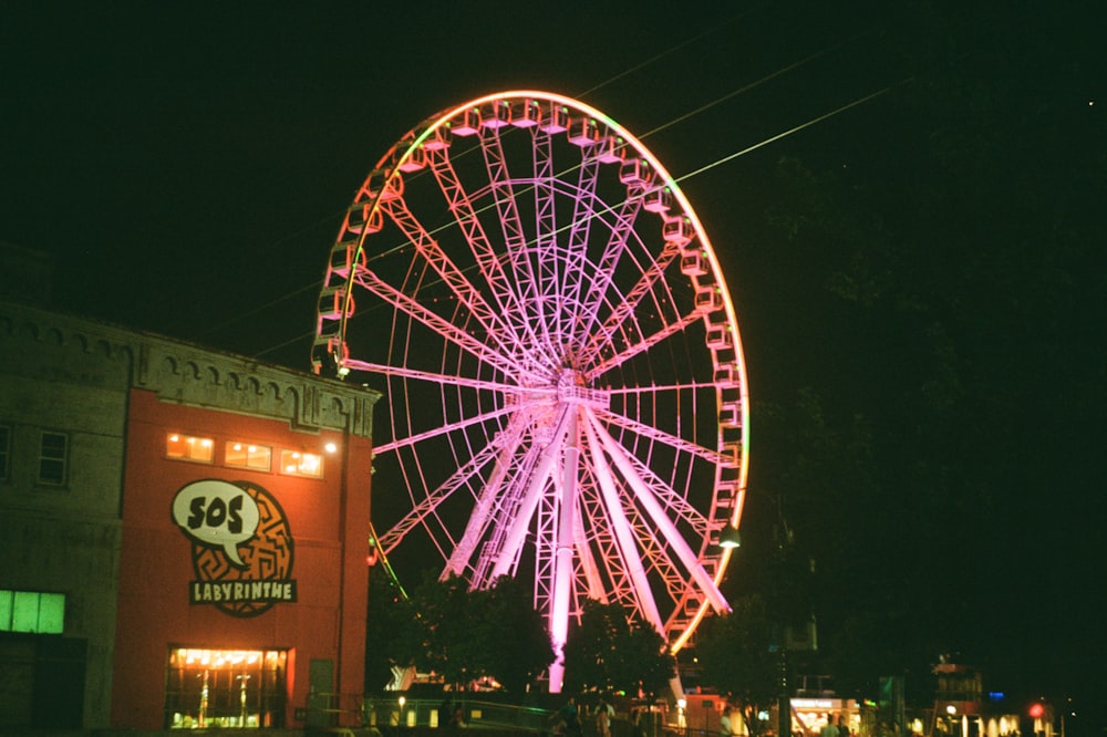 ferris wheel with lights turned on during night time