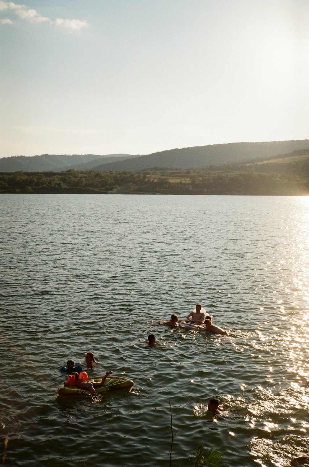 people swimming on sea during daytime