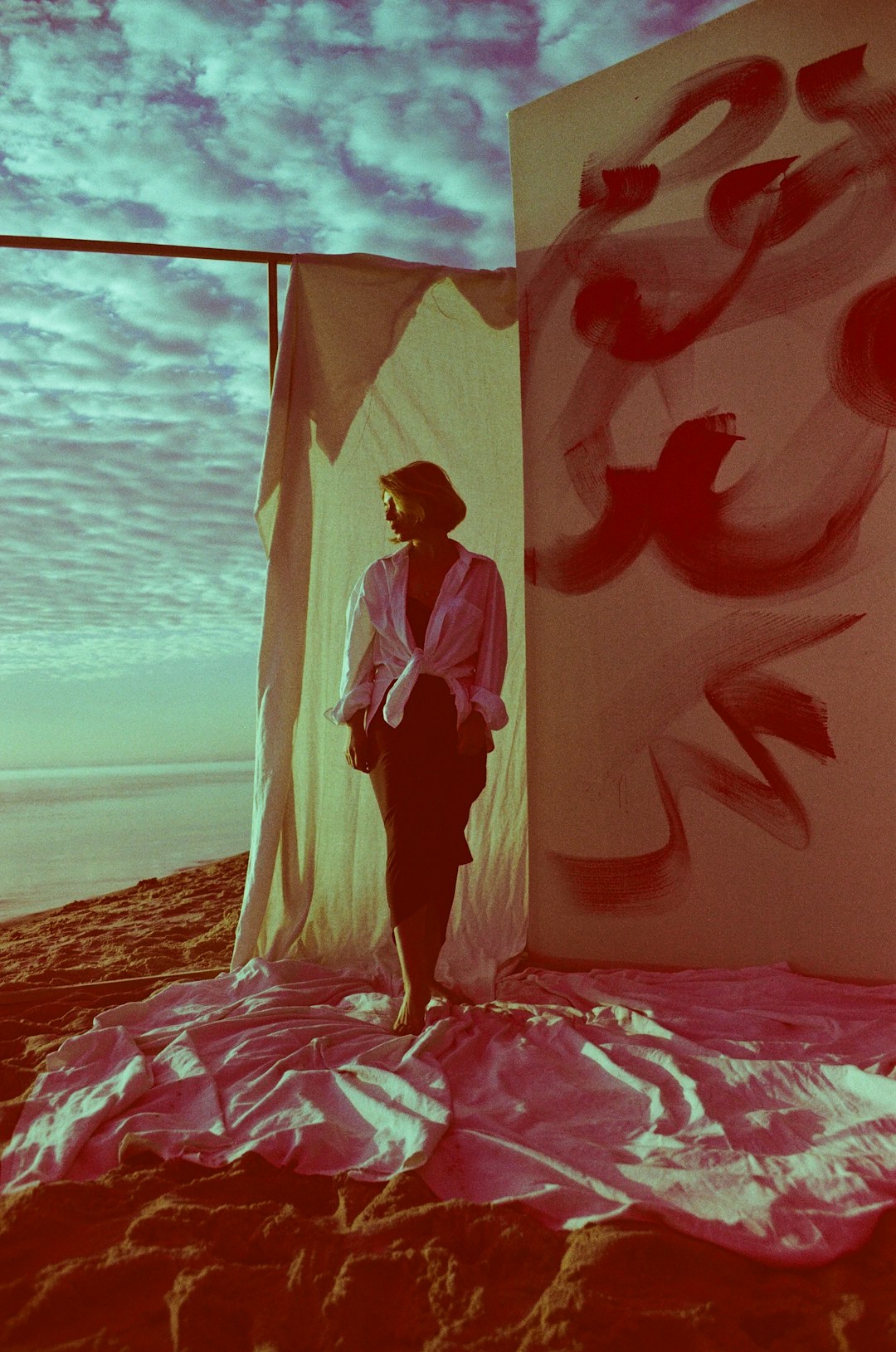 woman in white dress standing on pink textile