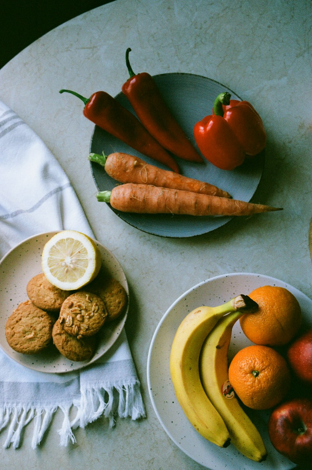 orange and banana fruits on white ceramic plate