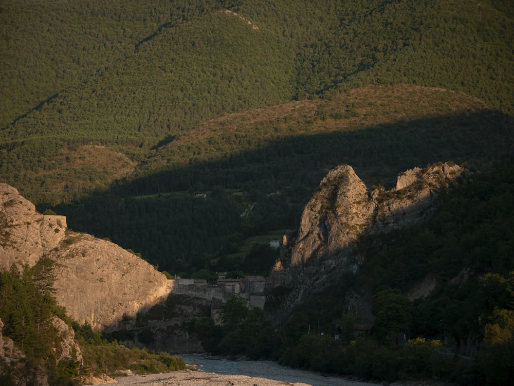 green mountain beside river during daytime