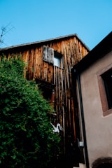 A wooden house facade being refreshed with gentle soda blasting outdoors