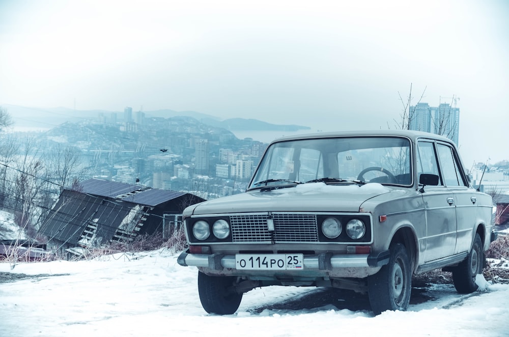 white car on snow covered ground during daytime