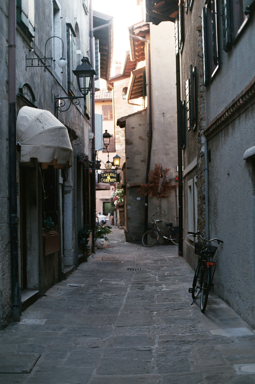 black bicycle parked beside brown concrete building during daytime